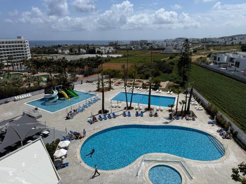 an overhead view of a large swimming pool at Papouis Protaras Hotel in Protaras