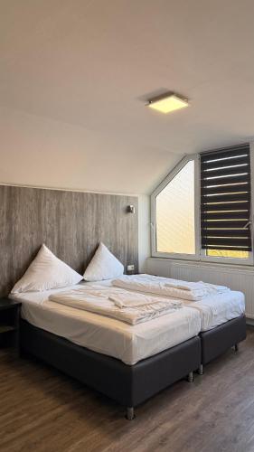 a large bed in a bedroom with a window at Casino Hotel Hamm in Hamm