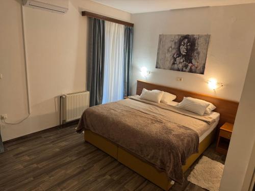 a hotel room with a bed with two pillows at Hotel Žućo in Biograd na Moru