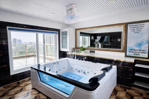 a large bath tub in a room with a large window at Shri krishna paradise in Panvel