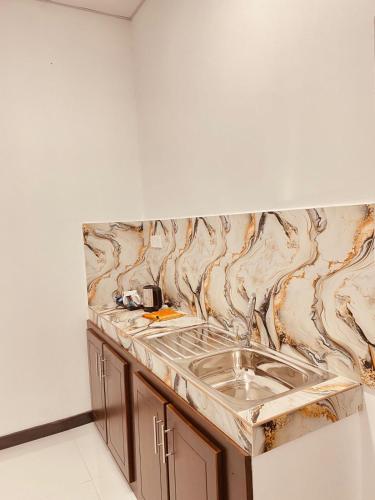 a kitchen with a marble counter top with a sink at Sky Vista by Jonathan's way in Negombo
