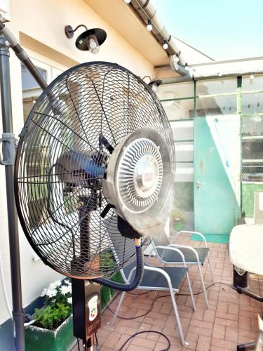 a fan sitting on top of a patio at Rumbach Terrace Apartment in Budapest