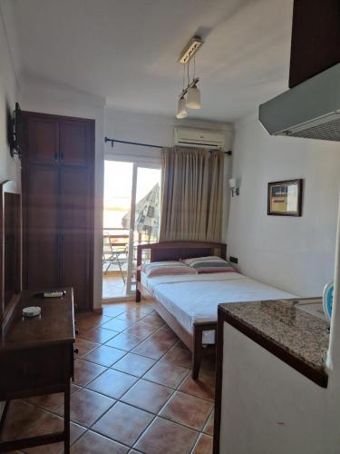 a bedroom with a bed and a view of a balcony at Studio de luxe avec piscine in Tétouan