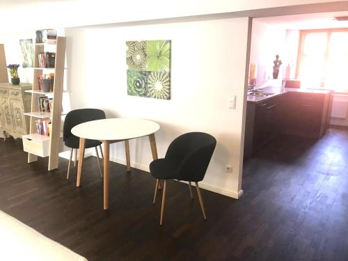 a dining room with a table and two chairs at Ferienwohnungen Haus Castello App9 in Aschau im Chiemgau