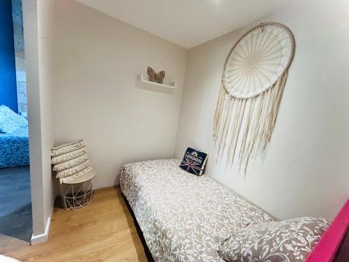 a small bedroom with a bed and a window at Logis des vignes in Saint-Émilion
