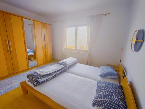 a bedroom with two twin beds and a window at Panorama Sky Apartment -11 min by walk to Old Town - Free Parking in Sarajevo