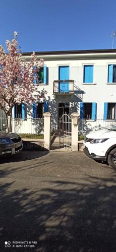 a building with a fence and a car parked in front at Mirella's House in Padova