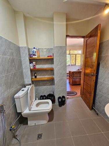 a bathroom with a toilet and a sink at Island Nest in Virac