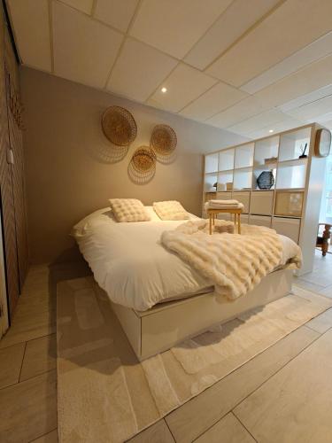 a bedroom with a bed with a table on it at Studio 13 in Dronrijp