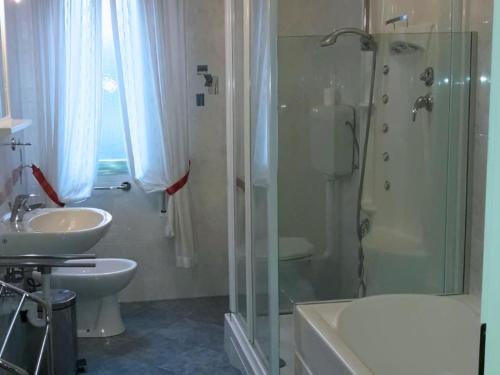 a bathroom with a shower and a sink and a toilet at Villa Terme in Grado