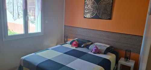 a bedroom with a bed with two stuffed animals on it at Gîte myosotis Piscine Privée 4 Chambres in Lagorce