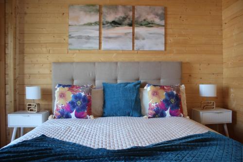 a bedroom with a bed with three paintings on the wall at Casa da Camélia in São Roque do Pico