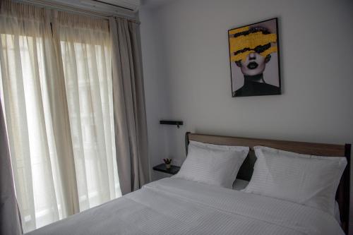 a bedroom with a bed and a picture on the wall at The ViewPoint VP3 in Mytilene
