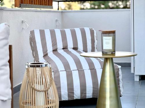 a couch and a table on a patio at Covea by the Sea Boho Seaside Apartment, 400 m from the Beach in Perea