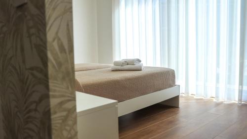 a bedroom with a bed with a towel on it at L'Eden di Nicolas in San Costantino Calabro
