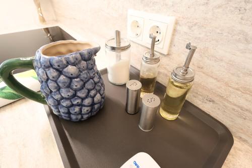 a counter with a coffee cup and two bottles on it at Hofgassenhaus LIMUN in Mörbisch am See