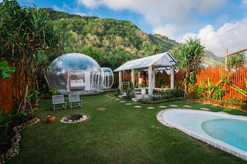 a backyard with a dome house and a swimming pool at Bubble 2 - Sunset Private Pool Dome Uluwatu in Uluwatu