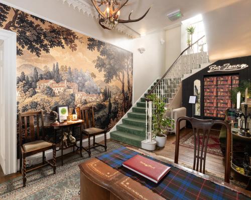 a room with a staircase with a painting on the wall at Dunfallandy House Hotel in Pitlochry