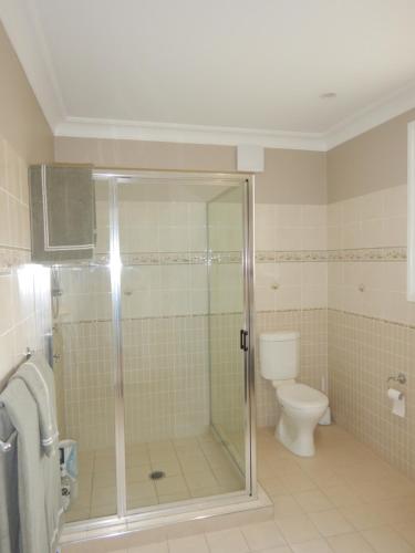 a bathroom with a shower and a toilet at The Honeypot in Balmoral