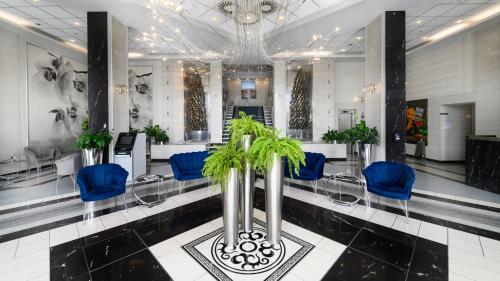 a waiting room with blue chairs and a salon at Continental Forum Sibiu in Sibiu
