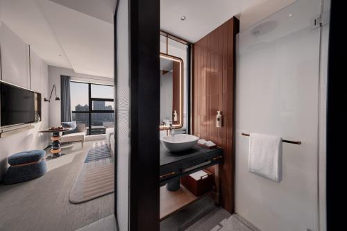 a bathroom with a sink and a mirror at 苏州云启一方酒店-凯悦尚选 in Suzhou