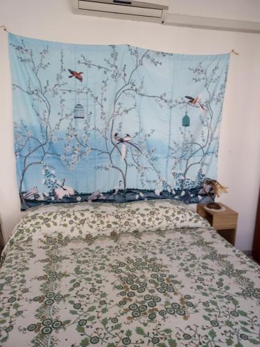 a bedroom with a bed with a blue wall at B&B Casa Rosati in Sampieri