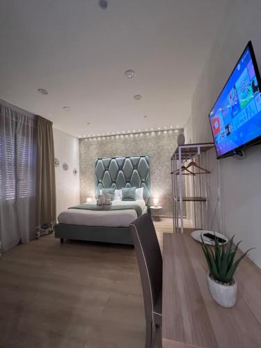 a bedroom with a large bed and a flat screen tv at Stay & Fly in Naples