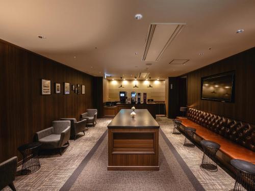 a waiting room with a long table and chairs at Yokohama Sakuragicho Washington Hotel in Yokohama