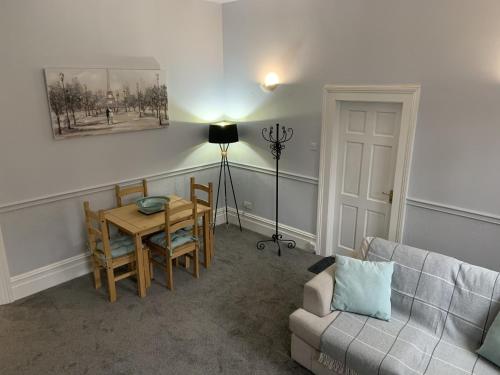 a living room with a table and a couch at Hursley Lodge in Lincoln