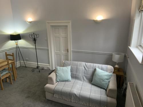 a living room with a couch and a table at Hursley Lodge in Lincoln