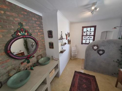a bathroom with two sinks and a mirror on the wall at Django's in Riebeek-Kasteel