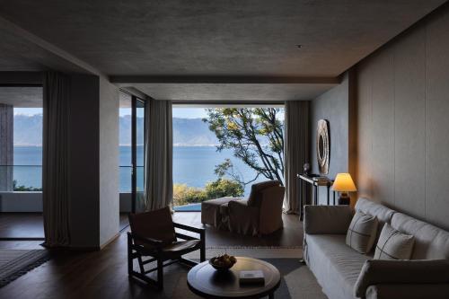 a living room with a couch and a view of the ocean at Arcadia anyin qingshan hotel in Dali Shuanglang