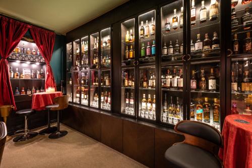 a bar with lots of bottles of alcohol at Dunfallandy House Hotel in Pitlochry