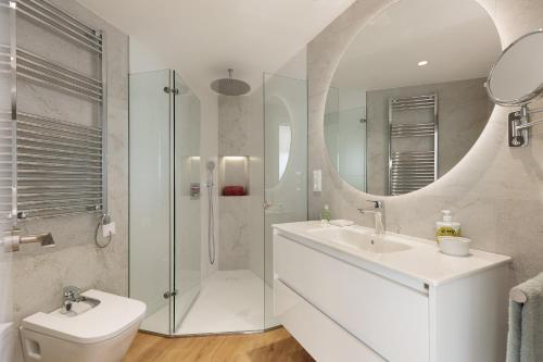 a bathroom with a toilet and a sink and a mirror at La Escala- Costa Brava pool duplex apartment in L'Escala
