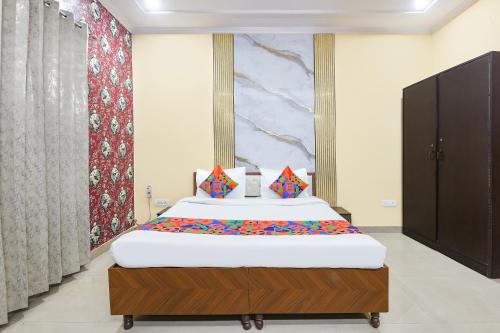 a bedroom with a large bed in a room at FabHotel Sager Inn in Gurgaon
