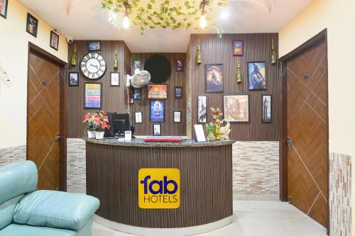 a hotel lobby with a reception counter and a clock at FabHotel Sager Inn in Gurgaon