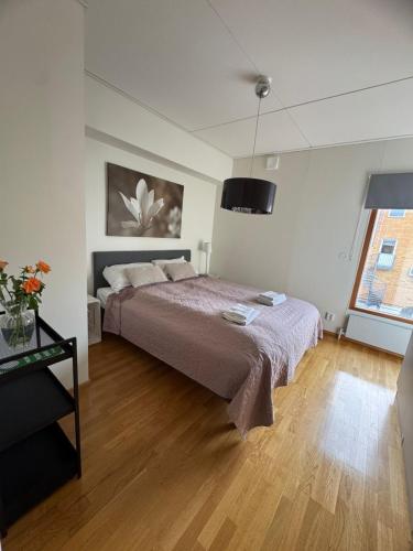 a bedroom with a large bed and a wooden floor at Strandis in Mariehamn
