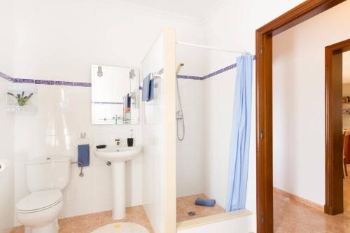 a bathroom with a toilet and a sink at Villa Son Tretze by Villa Plus in Biniparrell