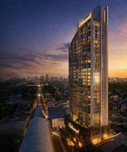 a lit up building in a city at night at Oakwood Suites Tiwanon Bangkok in Nonthaburi