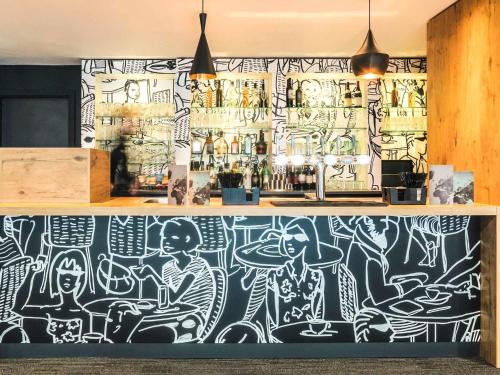 a wall with graffiti on it in a restaurant at ibis Liverpool Centre Albert Dock – Liverpool One in Liverpool