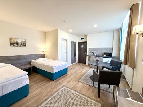 a hotel room with a bed and a desk at Terminal Park in Bischofsheim