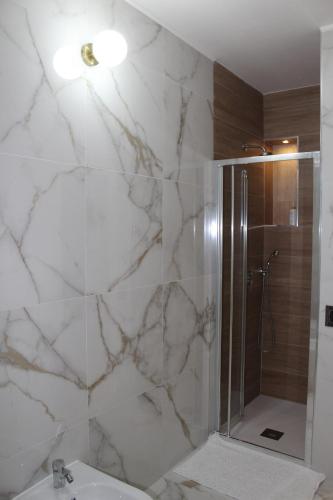 a bathroom with a shower and a sink at TedHouse in Praia a Mare