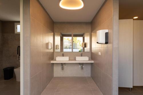a bathroom with two sinks and a mirror at Cielito Lindo Tu hogar temporal con encanto in Torrent