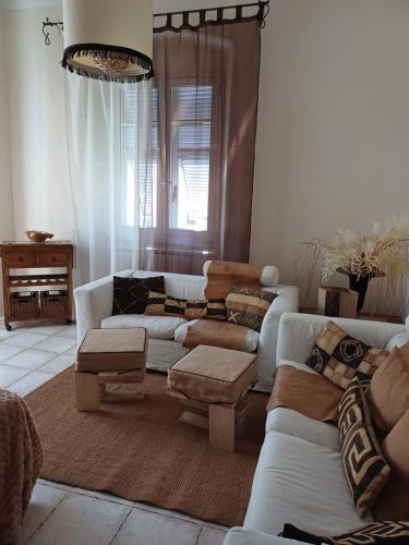 a living room with couches and a table at Marina's House in La Spezia