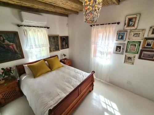 a bedroom with a bed and pictures on the wall at Django's in Riebeek-Kasteel