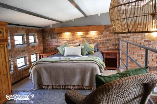 a bedroom with a bed in a brick wall at Olive Branch in Dullstroom