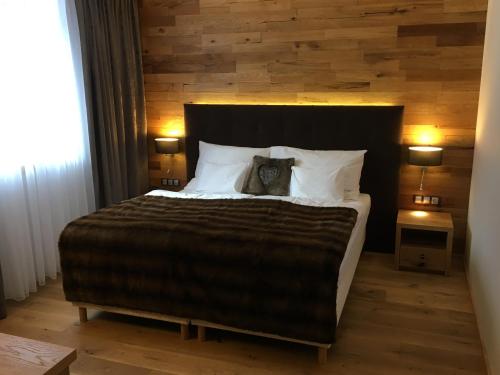 a bedroom with a large bed with two pillows at Penzion Jurášek in Kunčice pod Ondřejníkem