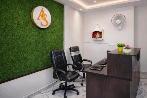 an office with a desk and a dollar sign on the wall at Ayodhya Stay in Ayodhya