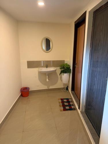 a bathroom with a sink and a mirror at Bliss Stay in Mūvattupula