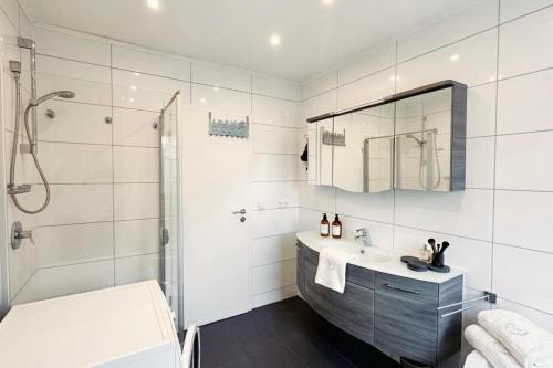 a bathroom with a tub and a sink and a shower at Loft Nagoldtal in Pforzheim